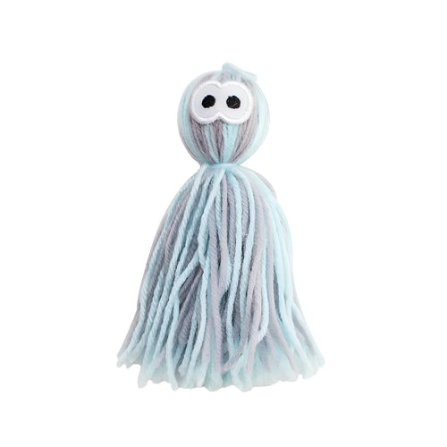 Blue grey wool cat toy with teaser stick hanging from furniture