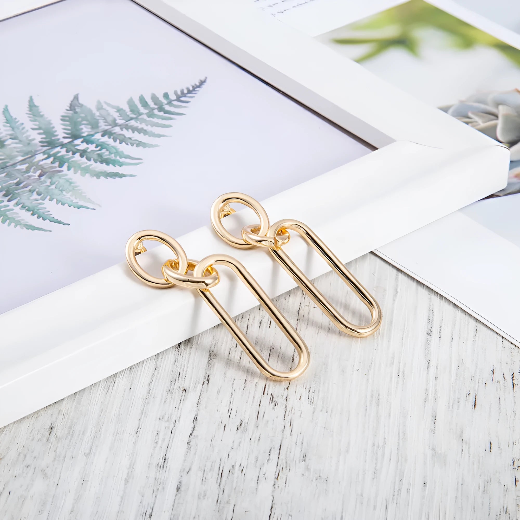 Geometric sterling silver needle hoop earrings with line and ring design elements