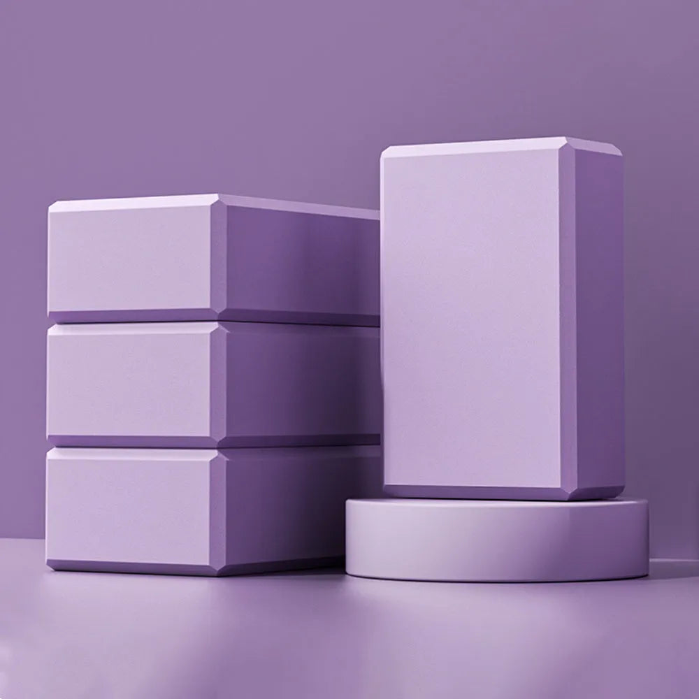 Blue high-density EVA yoga block on a gym mat, showing dimensions for scale.