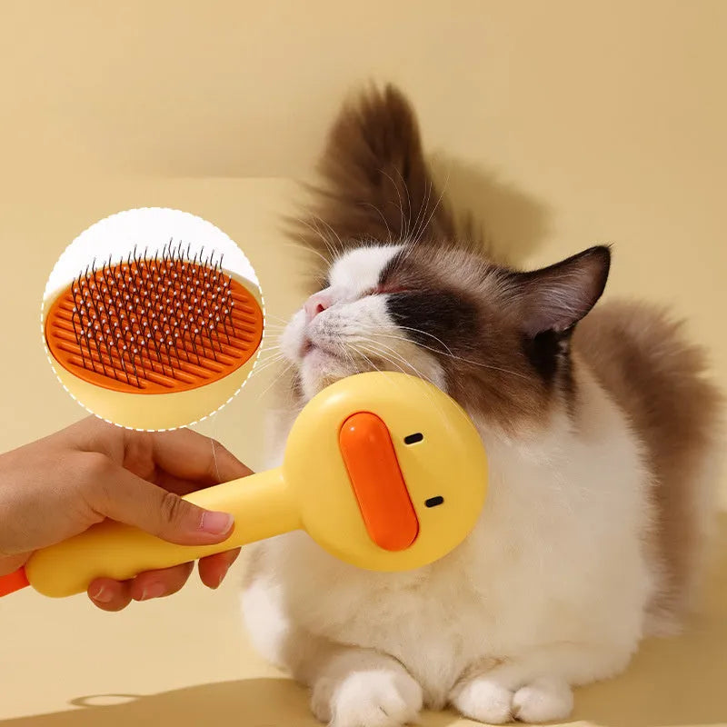 Yellow and white pet grooming comb with duck design and needle teeth for cats and dogs.