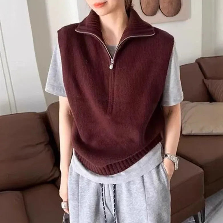 Retro half-zip sleeveless knit vest in solid colour polyester mesh fabric on a hanger.