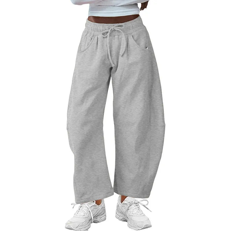 Loose cropped cotton sweatpants with elastic drawstring waist and side pockets in multiple colour options