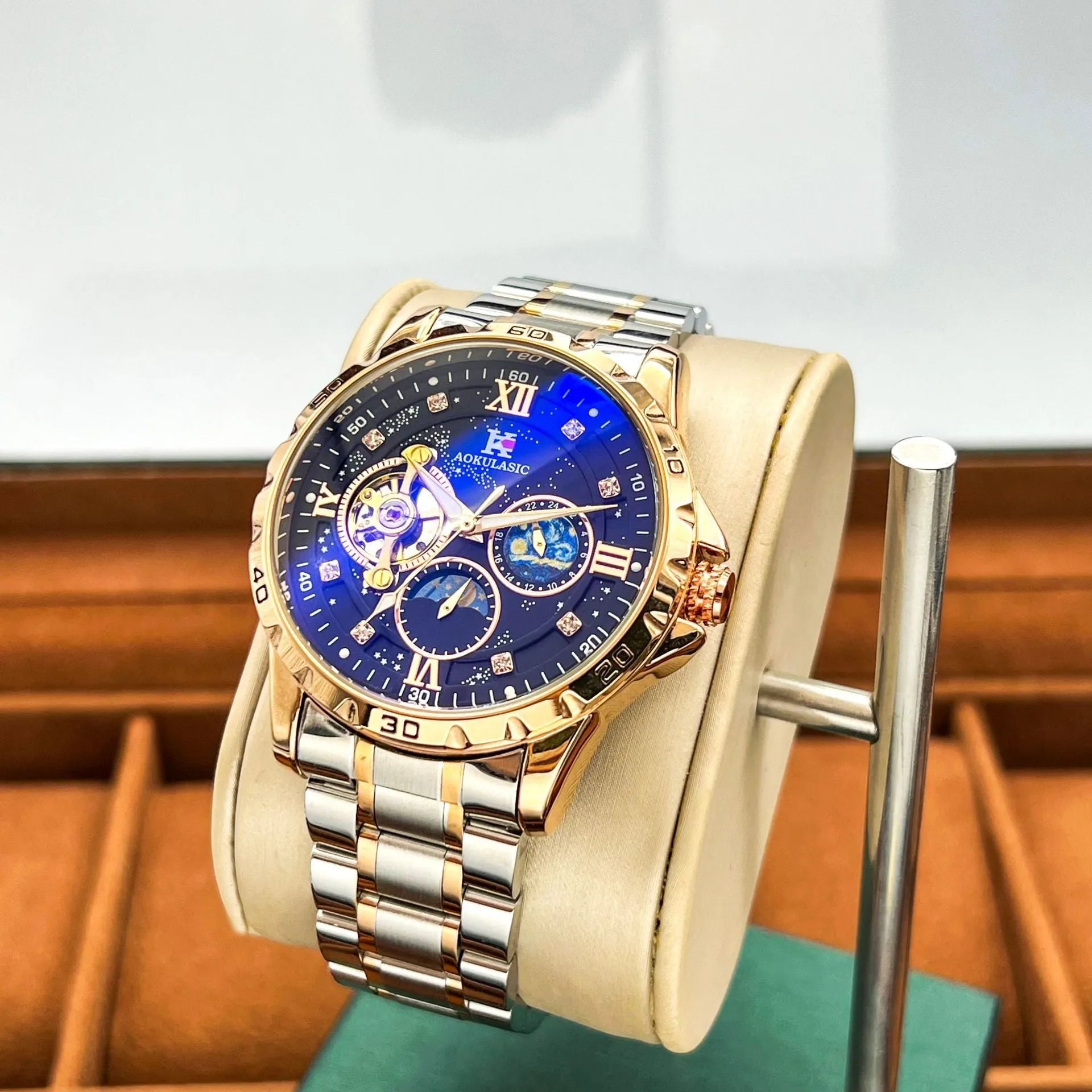 Automatic mechanical men's watch with large black dial and rose gold case, showing skeleton back.