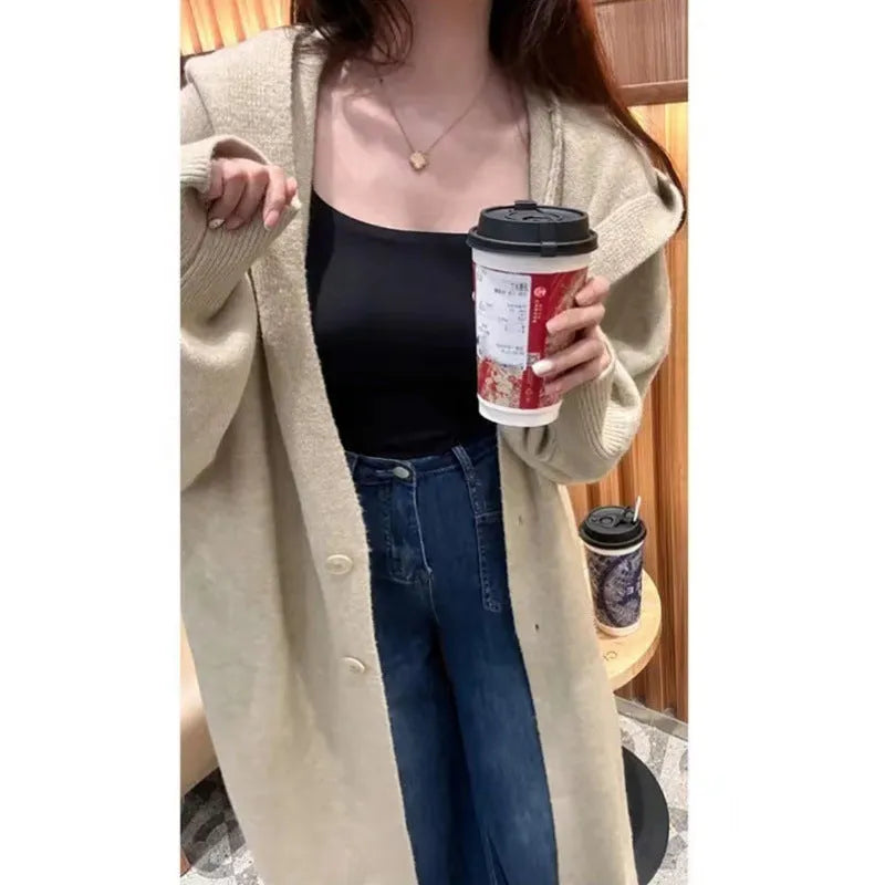 Women's long hooded cardigan in wool blend fabric showing below-the-knee length and loose fit silhouette
