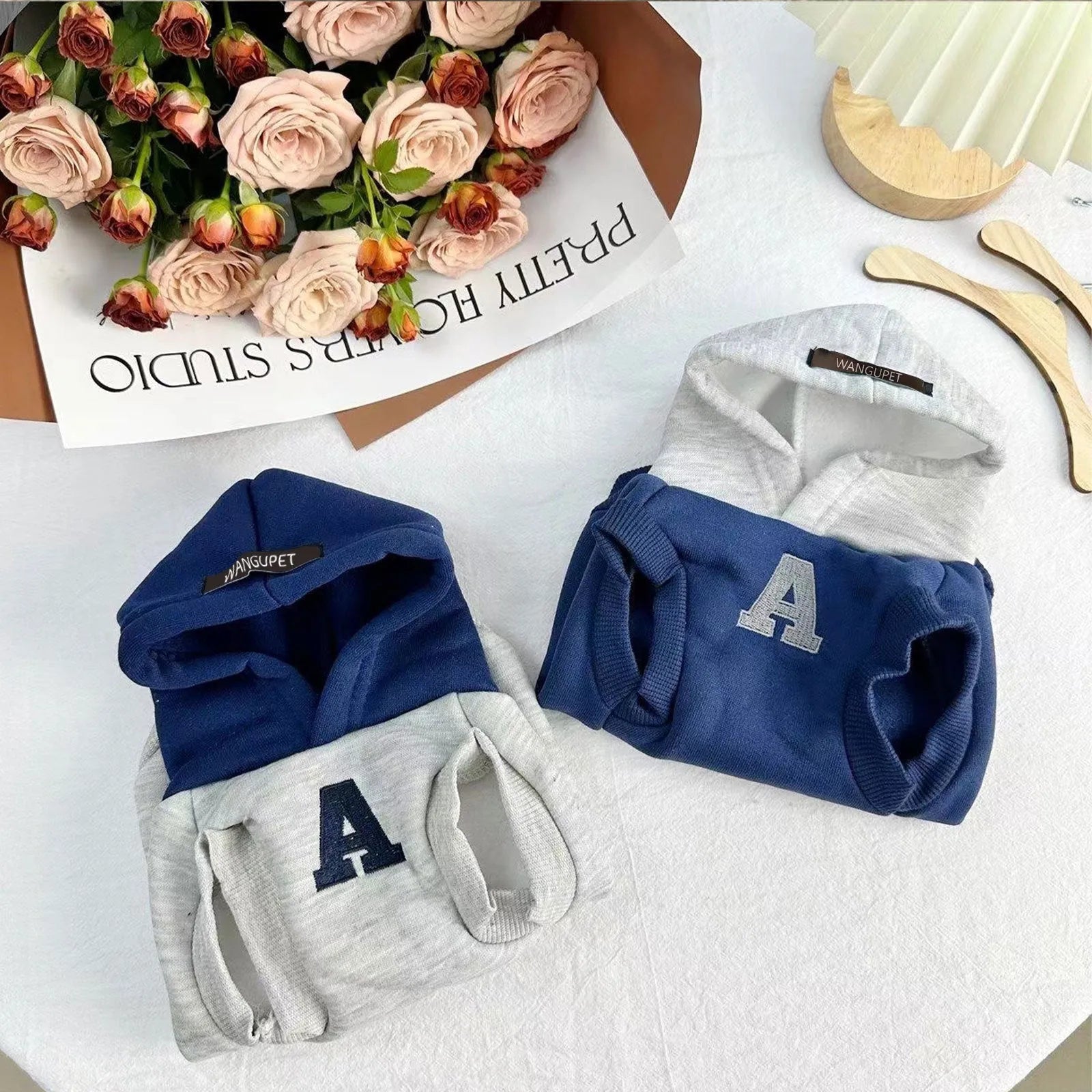 Blue and grey white striped reflective lettering on a slim-fit pet hoodie for cats and dogs.