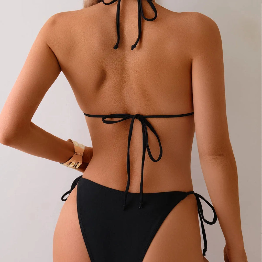 Black women's bikini swimsuit with metal bead detailing and split bottom design