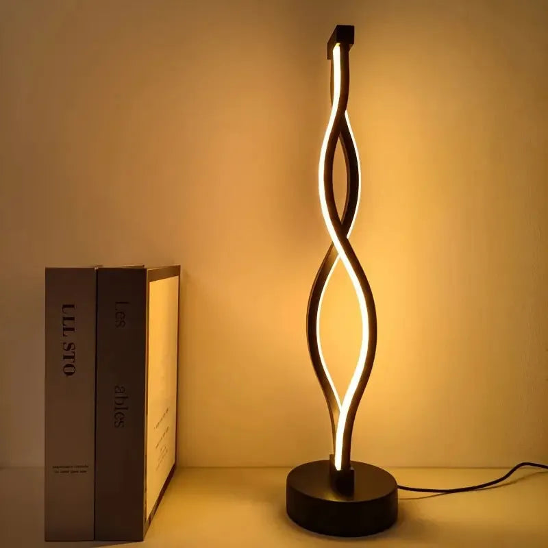 Black aluminium desk lamp with touch dimming controls showing three colour temperature settings