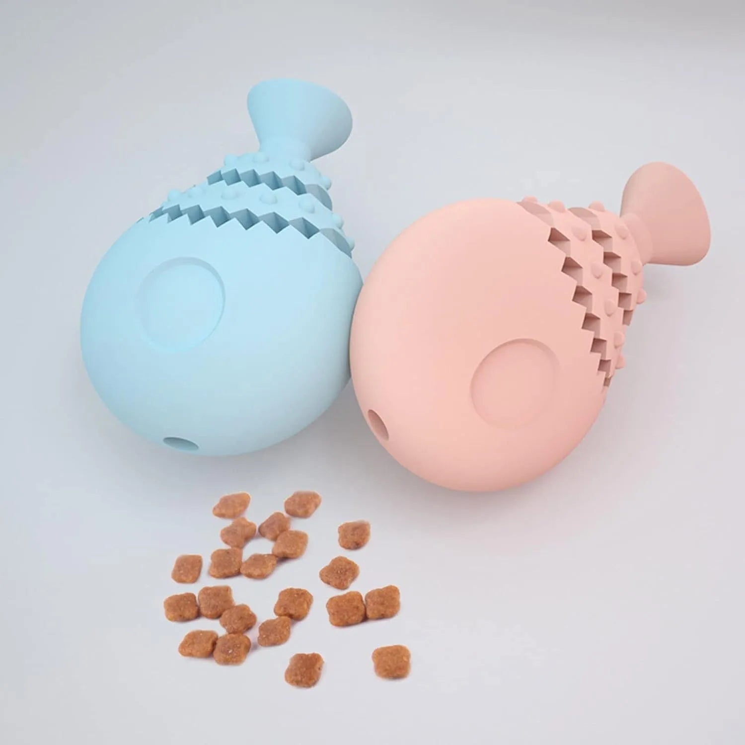 Blue green pink fish bone shaped dog chew toy with treat hole for dental cleaning.
