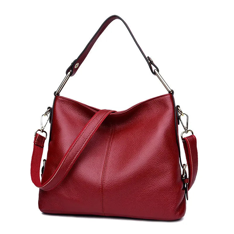 Square vertical genuine leather crossbody bag with multiple internal zipper compartments.