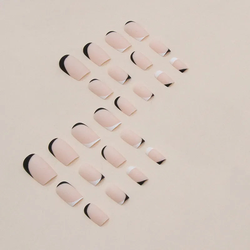 Black and white frosted press-on false nails with French manicure style and plastic wearable armour