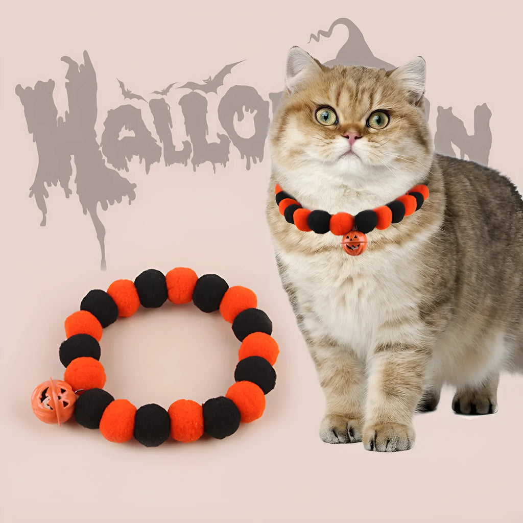 Orange Halloween cat collar with black pumpkin print and a silver bell, shown with an adjustable buckle.