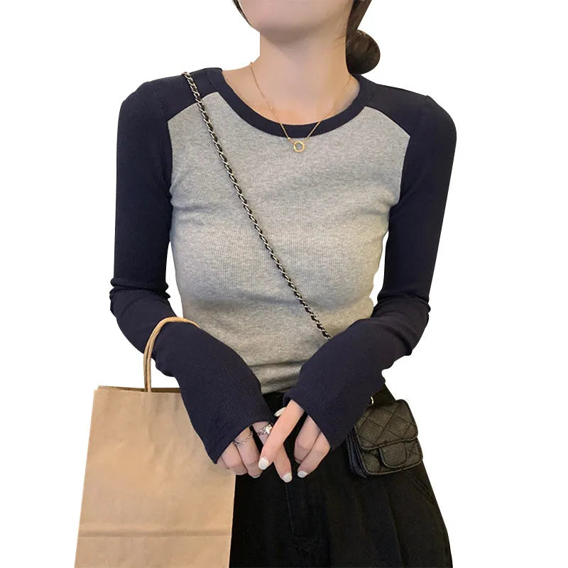 Women's dark blue viscose top with embroidery detail and long princess sleeves on a hanger.
