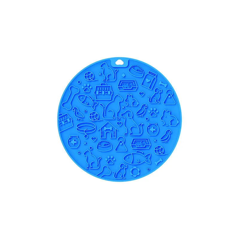 Round silicone pet licking mat with suction cup base in blue colour on smooth surface