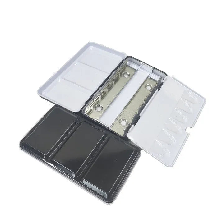 Square tinplate metal paint box for solid watercolour pigments in three folding sizes.
