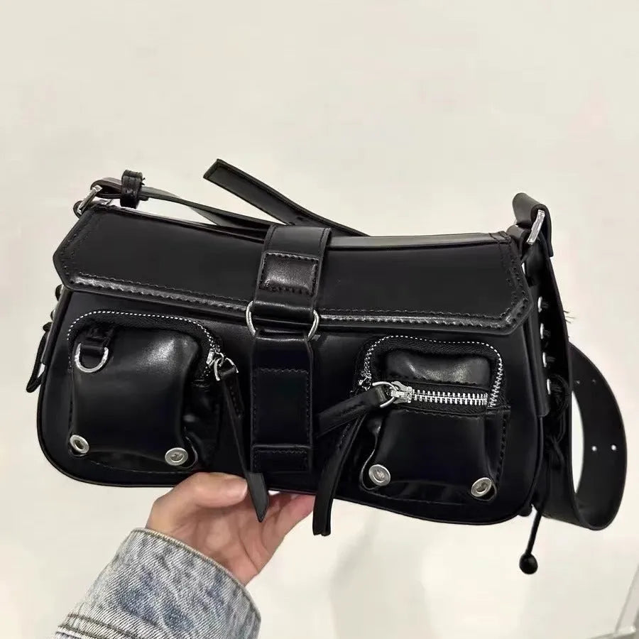 Black women's shoulder messenger bag with adjustable strap showing zippered change compartment interior