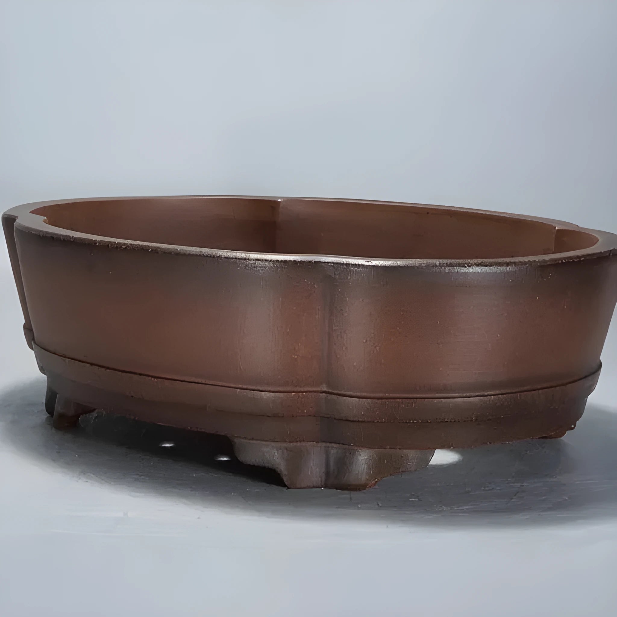 Classical purple clay ceramic bonsai pot with old pile finish, shown on a tabletop.