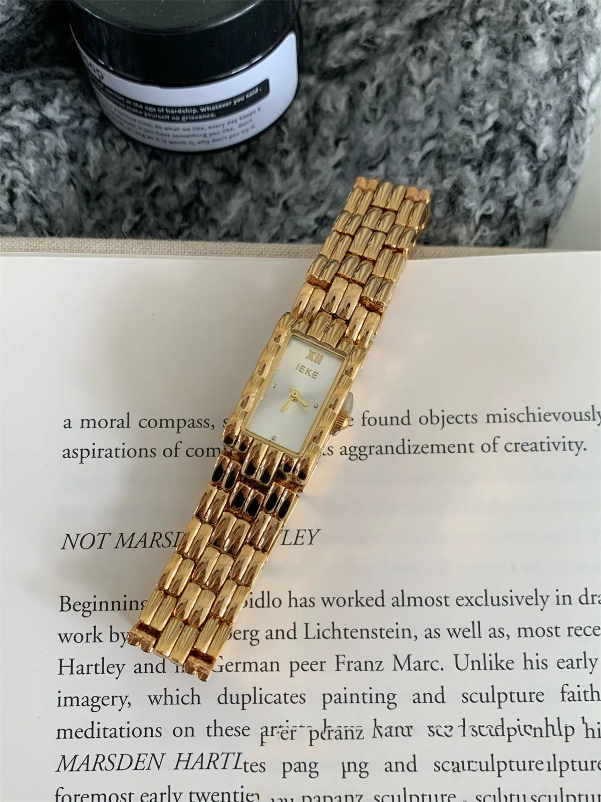 Women's silver and gold bracelet-style vintage watch with 15mm dial on wrist