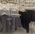 Women's loose grey knitted sweater and wide leg shorts two-piece loungewear set.