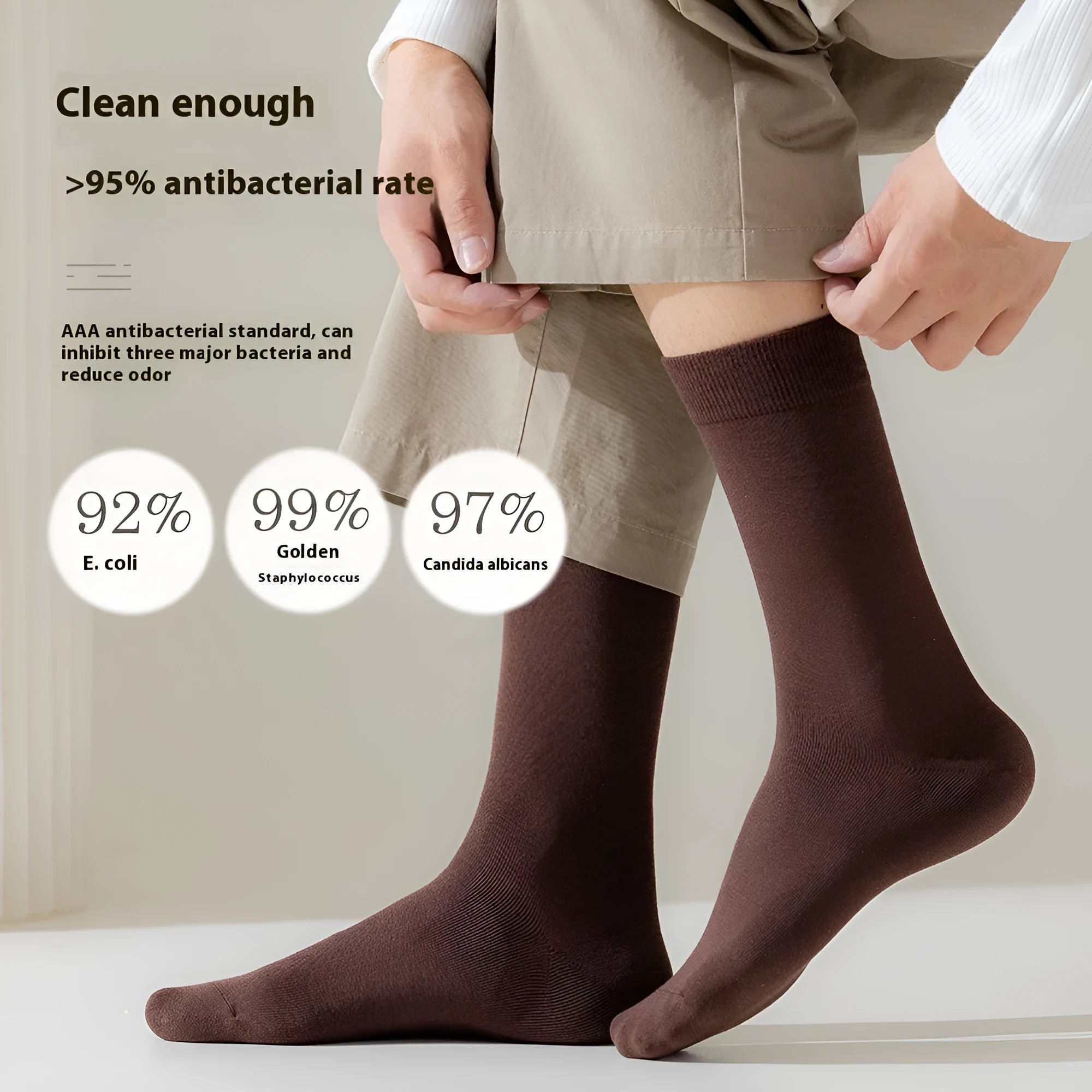 Men's solid colour pure cotton mid-calf business socks in beige, black, grey and blue shown folded.