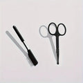 Black dual-sided pet grooming brush showing soft bristles for eyes on one end and a wider comb on the other