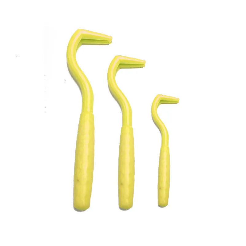 Set of three coloured ABS plastic tick removal hooks for dogs on a white background.