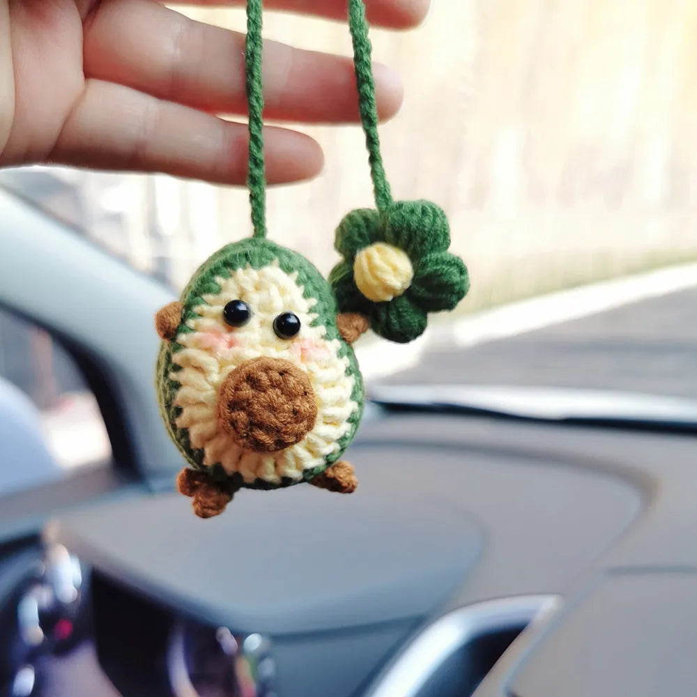 Handmade crocheted wool car pendant in avocado, pink rainbow, or red rainbow colours with cartoon styling