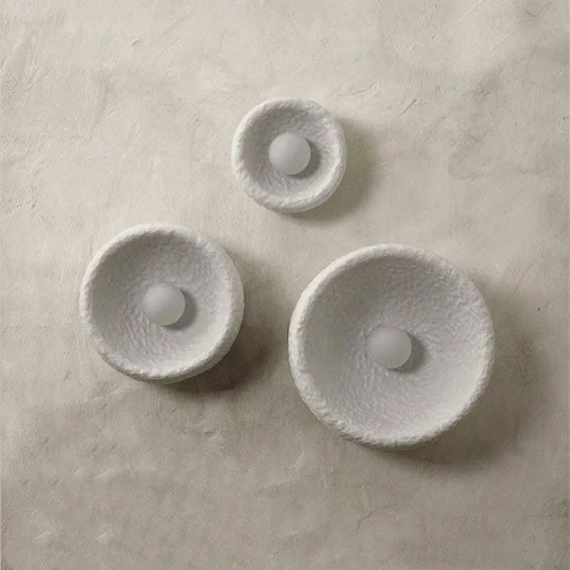 Japanese-style minimalist wall lamp with resin shade in three diameter options on modern interior wall
