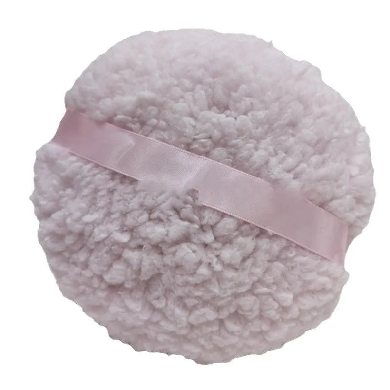Oversized white plush powder puff measuring 150mm by 75mm for makeup application
