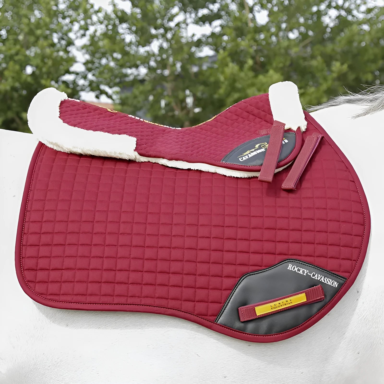 Equestrian riding saddle pad in wool blend with shock absorption foam for waist protection.