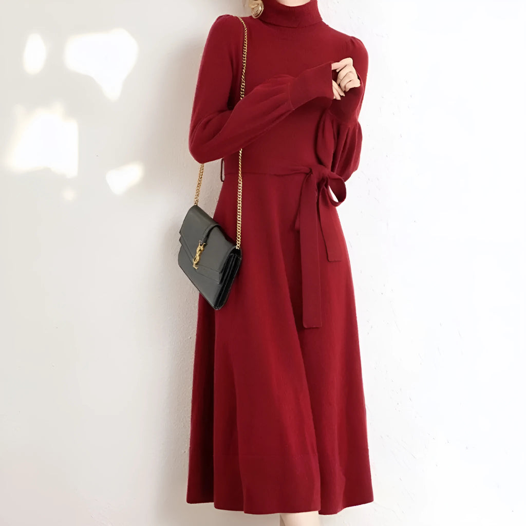 Loose-fitting turtleneck knit dress in rose red with long sleeves and a mid-length skirt.