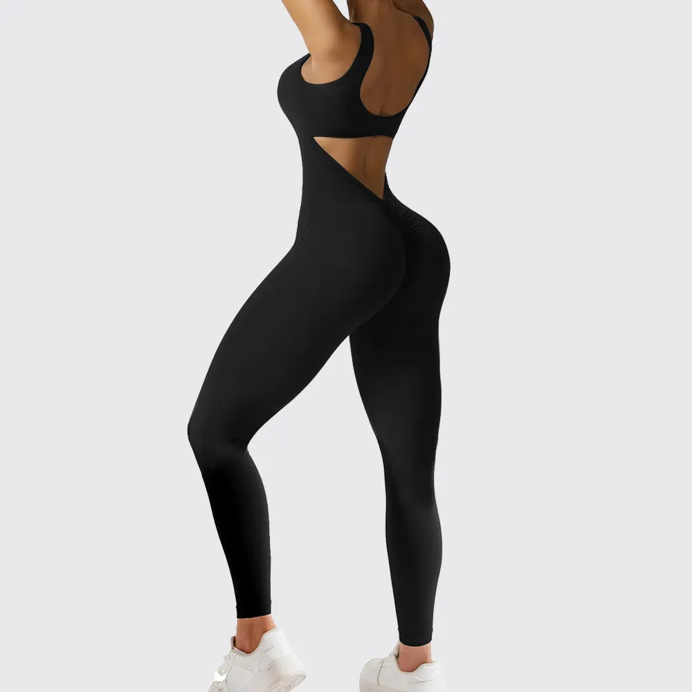 Woman wearing a sleeveless army green flare jumpsuit for yoga, showcasing the fashionable waist and trouser length.