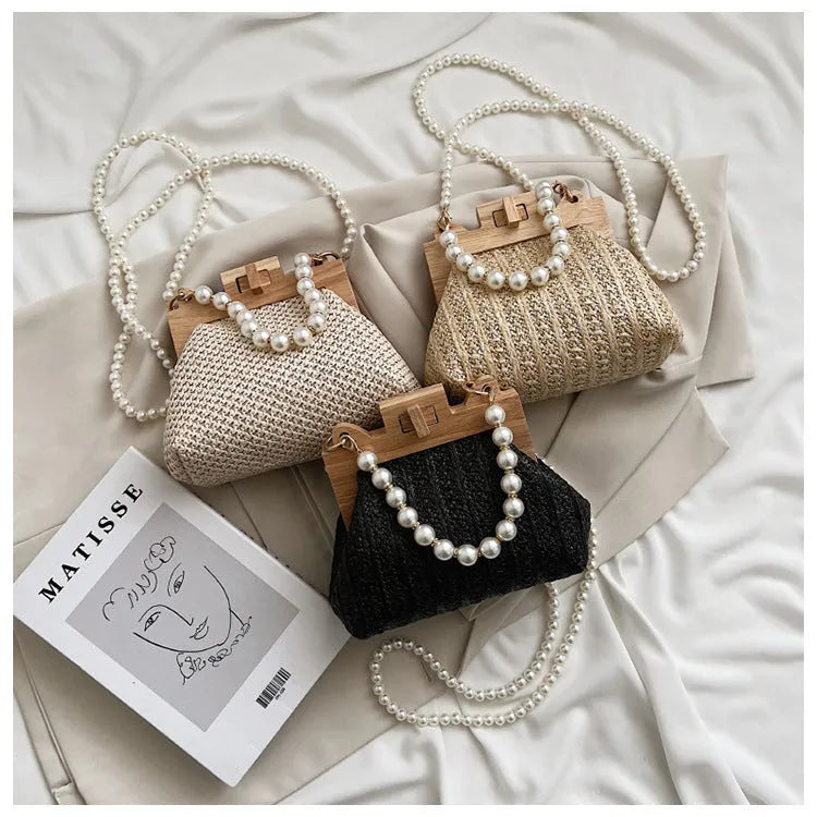 Women's straw shoulder bag with pearl chain strap in beige colour showing organised interior with compartments