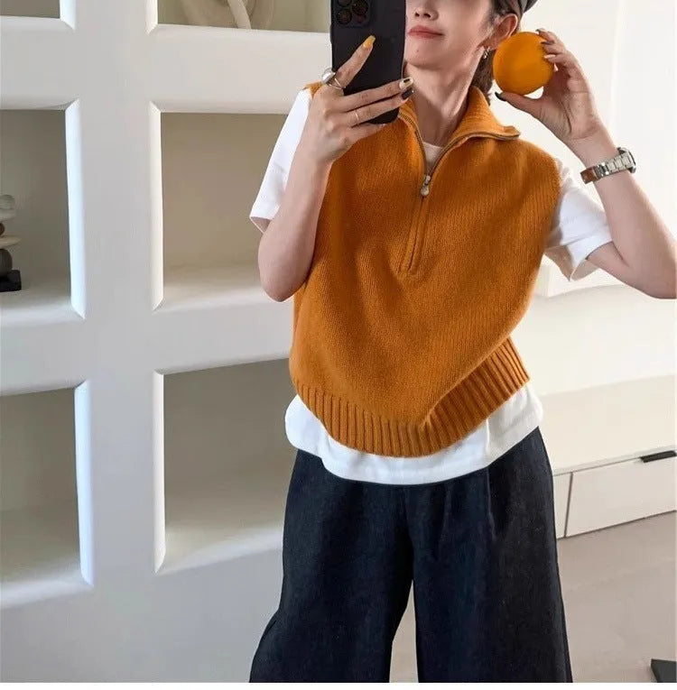 Retro half-zip sleeveless knit vest in solid colour polyester mesh fabric on a hanger.