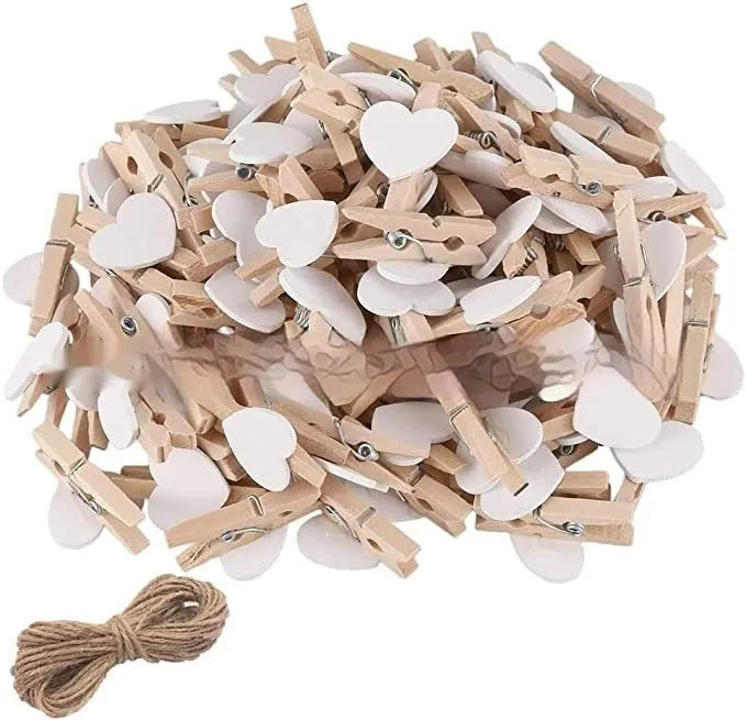 Five handmade wooden heart-shaped clips in red, white, and rose red on a plain background.