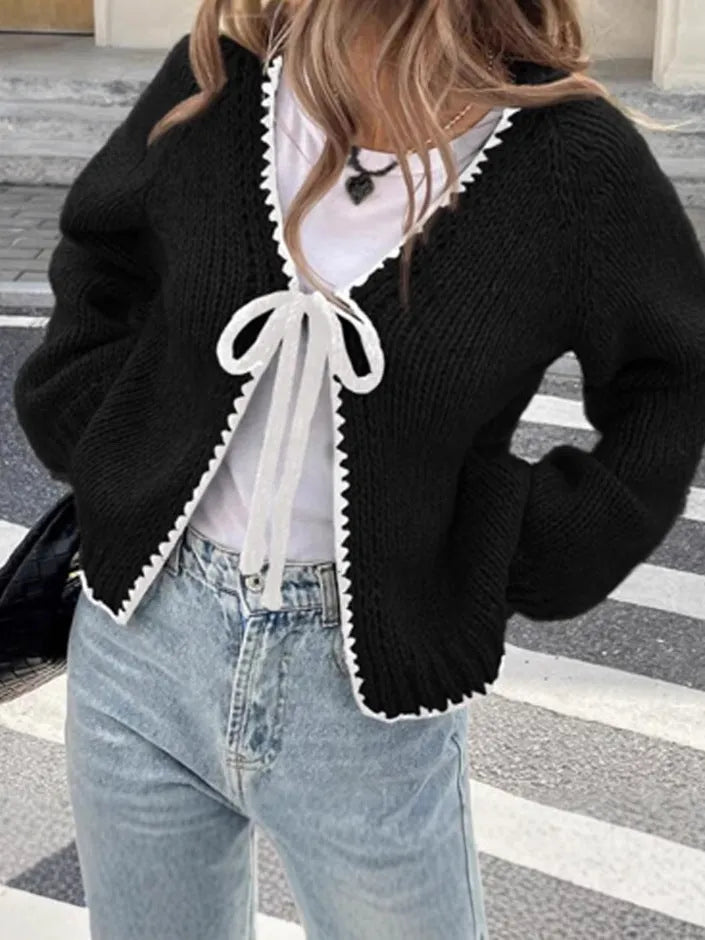 Grey lace-up sweater cardigan with long sleeves, a front crocheted flower, and a loose fit.