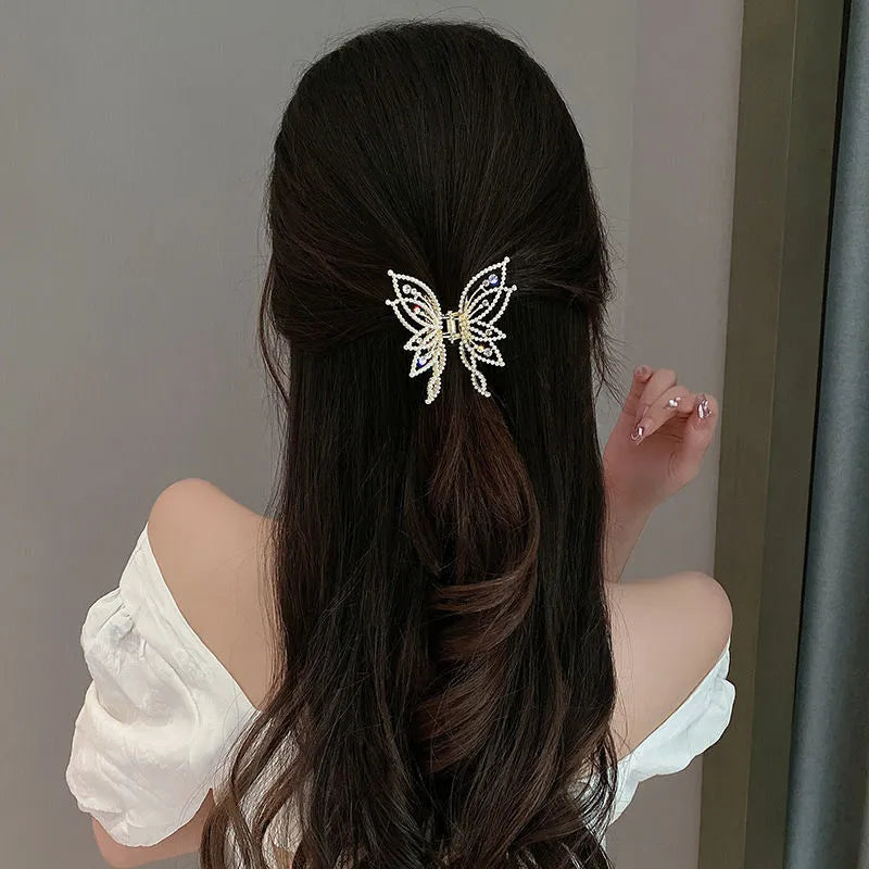Butterfly-shaped alloy hair clip barrette for women, shown in rhinestone and pearl style options.