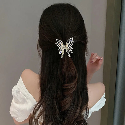 Butterfly-shaped alloy hair clip barrette for women, shown in rhinestone and pearl style options.