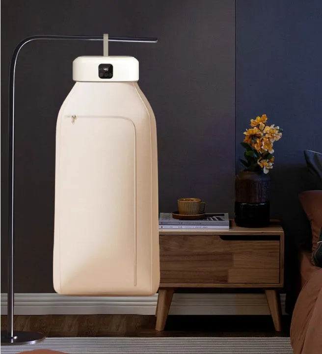 White cylindrical laundry dryer with remote control on surface showing compact 29cm length design