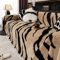 Zebra pattern flannel sofa slipcover in caramel colour, shown draped over a sofa.