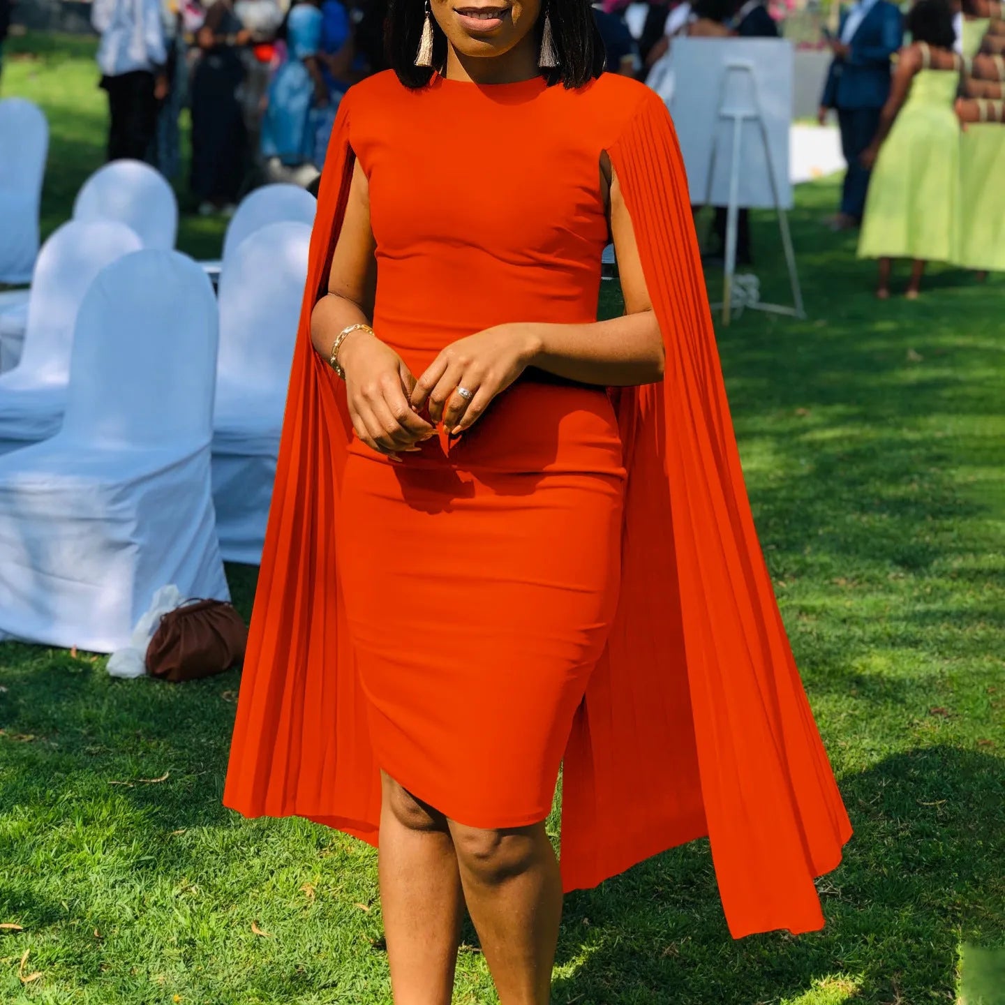 Long sleeve evening dress with pleated shawl detail in red, shown with high waist