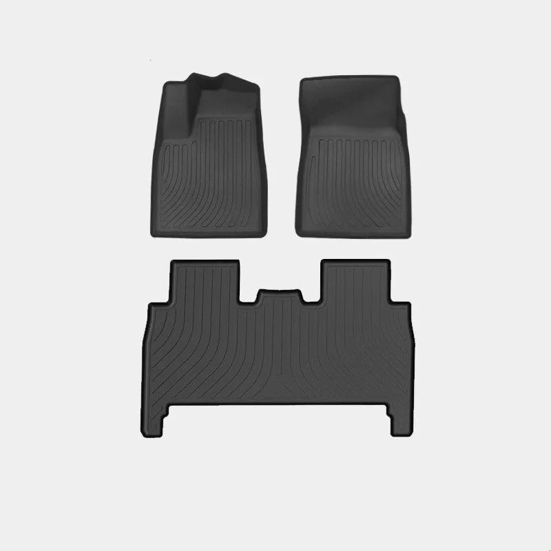 Tesla Model X black TPE rubber floor mats and boot liner set on car interior.