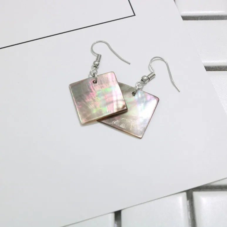 A pair of geometric-shaped women's earrings made from natural shell in a retro style.