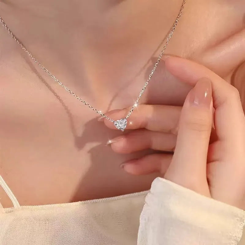 Silver women's necklace with heart-shaped pendant on copper chain