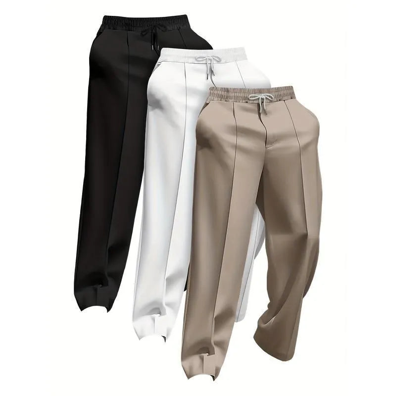 Pack of three men's solid colour loose-fit corduroy trousers on a hanger.