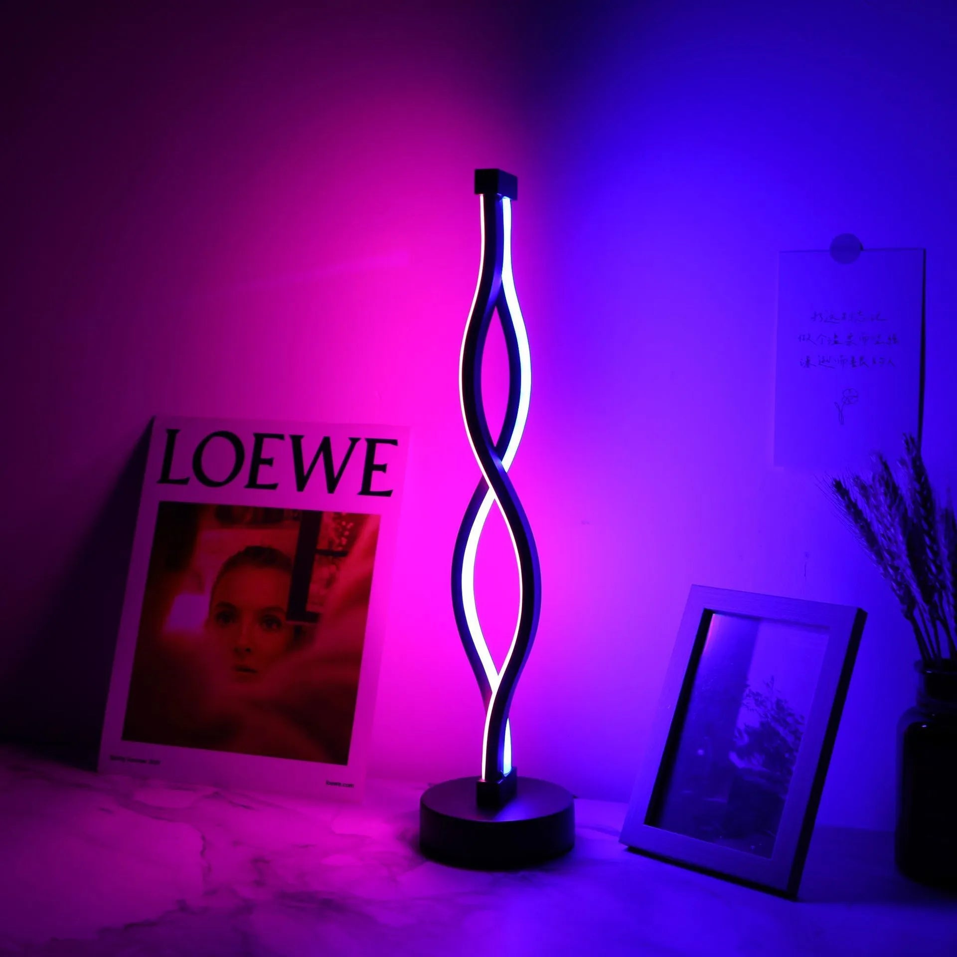Black aluminium desk lamp with touch dimming controls showing three colour temperature settings