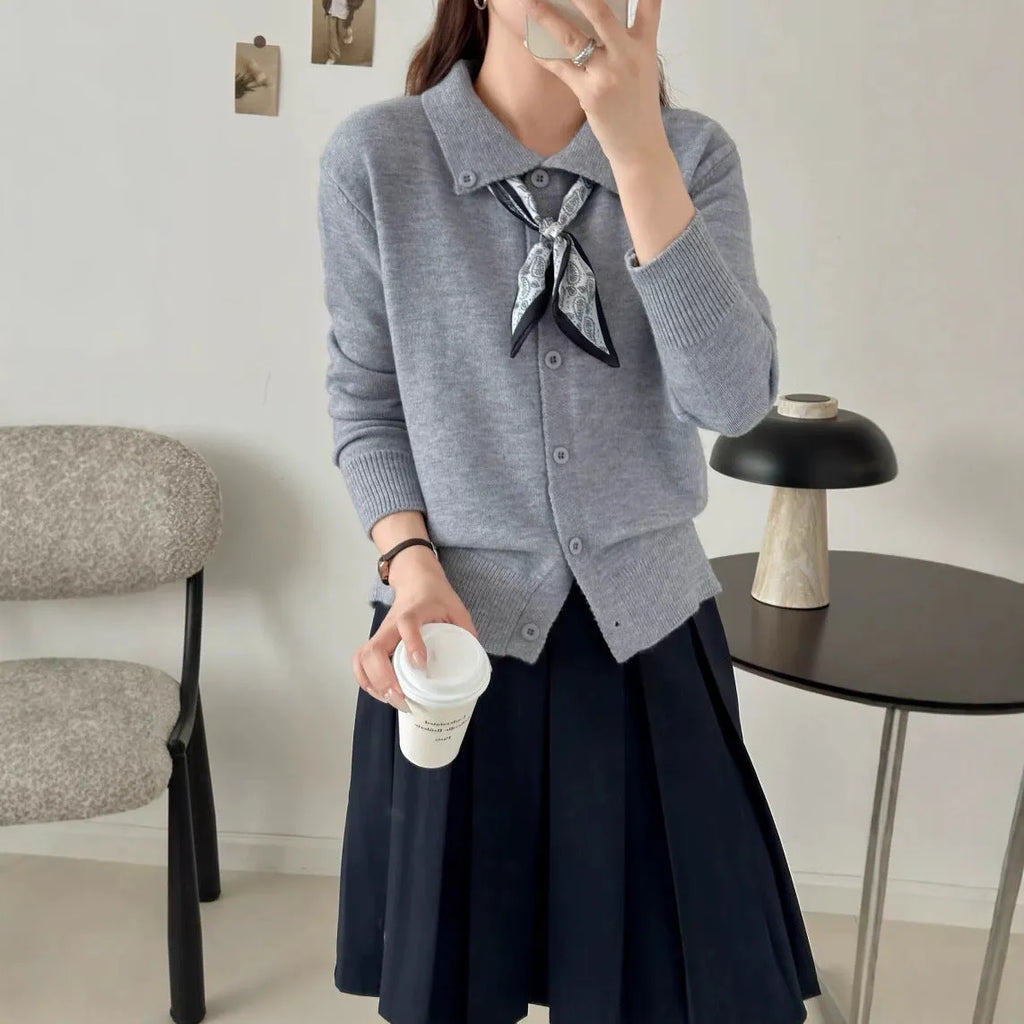 Women's beige lapel scarf collar acrylic cardigan sweater on a hanger.