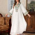 White long sleeve, long skirt Arabic robe for women on a hanger.