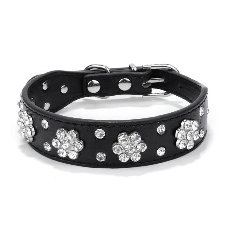 Black PU leather dog collar with rhinestone flowers and metal studs, showing the adjustable eyelets and D-ring.