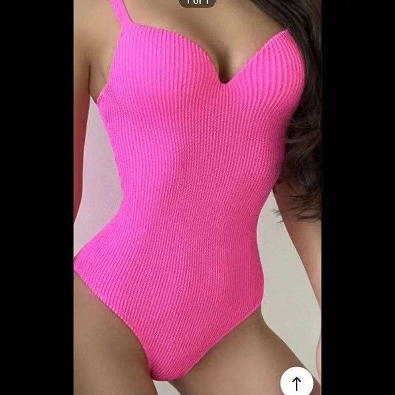 A women's sleeveless one-piece swimsuit on a hanger, shown in black, with other colour options available.
