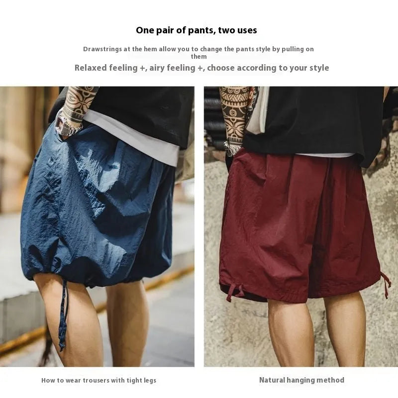 Men's loose fit nylon summer shorts in Prussian blue with embroidered design detail